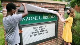 The New name of Naomi L. Brooks Elementary School is unveiled by students on June 22, 2021.
